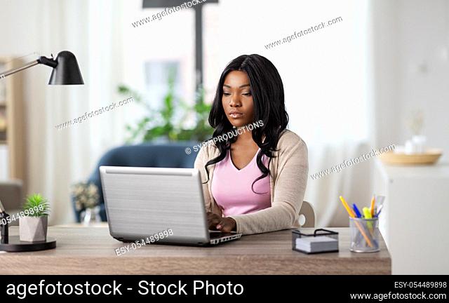 woman with laptop working at home office