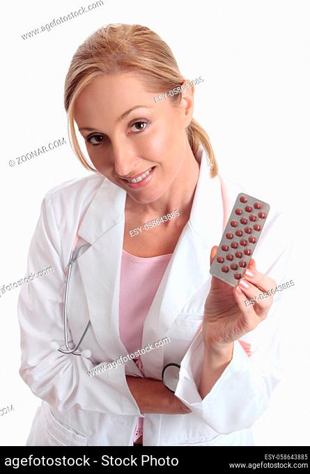 A female doctor holding or recommending medication in a foil blister pack