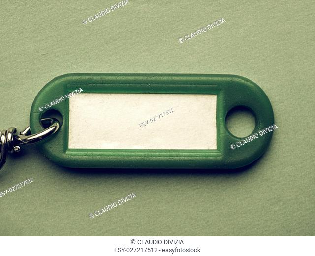 Vintage looking Green key ring with blank paper label with copy space