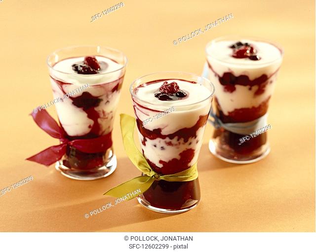 Dessert with stewed raspberries, blackberries, blueberries, redcurrants, blackcurrants mixed with yoghurt