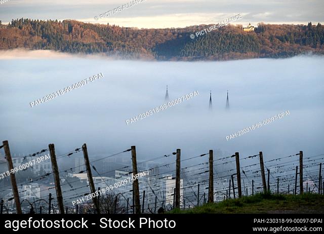 18 March 2023, Rhineland-Palatinate, Trier: The spires of Trier Cathedral and the Church of Our Lady rise out of the fog that lies over parts of the city