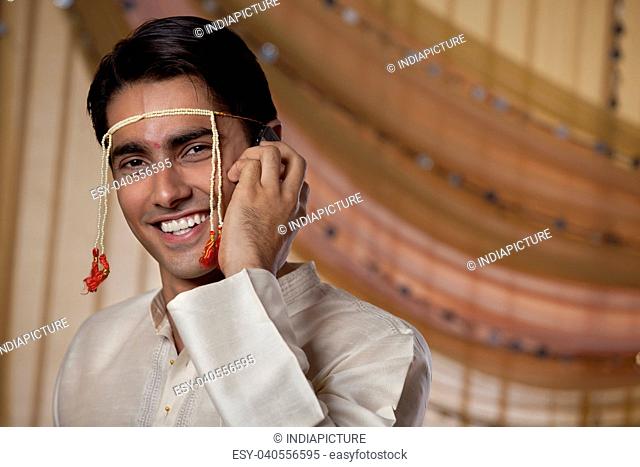 Handsome young man speaking on mobile phone