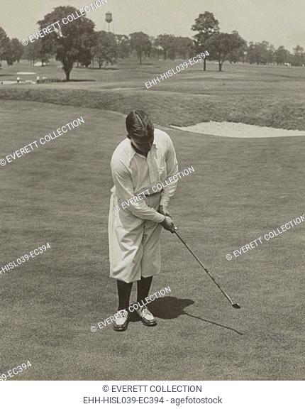 Bobby Jones, winner of 1929 National Open Golf Championship. He is sinking a putt with his famous putter, 'Calamity Jane'. - (BSLOC-2015-1-121)