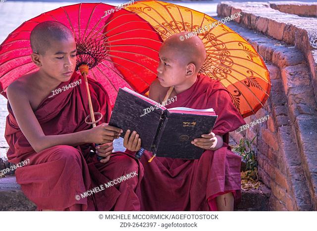 Two young monks study outside Bagan's Sularmuni Temple