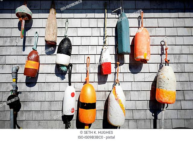 Variety of traditional fishing buoys hanging on wall, Lunenburg, Nova Scotia, Canada