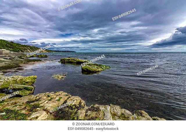 Beautiful seascape with rocks and stormy clouds