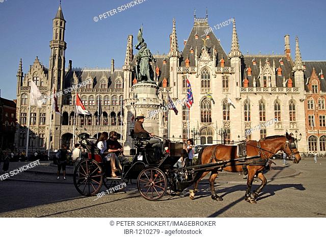Carriage with tourists on the Grote Markt square with Provinciaal Hof Provincial Court building in the historic center of Bruges, Belgium, Europe
