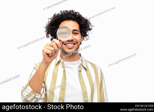 happy man looking through magnifying glass