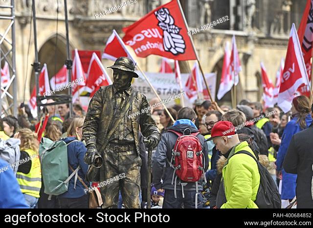 Theme image major strike day at Marienplatz in Munich on March 21, 2023. A street performer inwithten the strikers. Day care centers, clinics