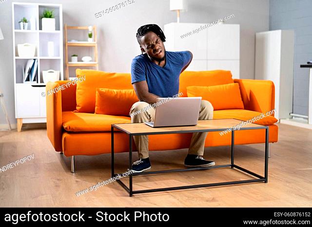 African Man With Pain Back In Home Office