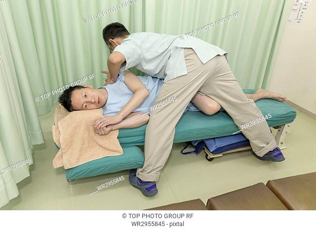 Doctor Manipulating the Body of A Man