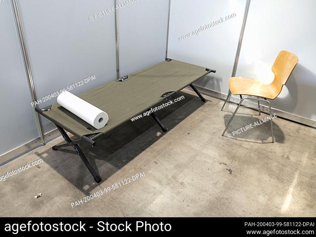 03 April 2020, Baden-Wuerttemberg, Freiburg: A camp bed and a chair stand in a room of the new ""fever outpatient clinic"" in the Sick-Arena at the Neue Messe