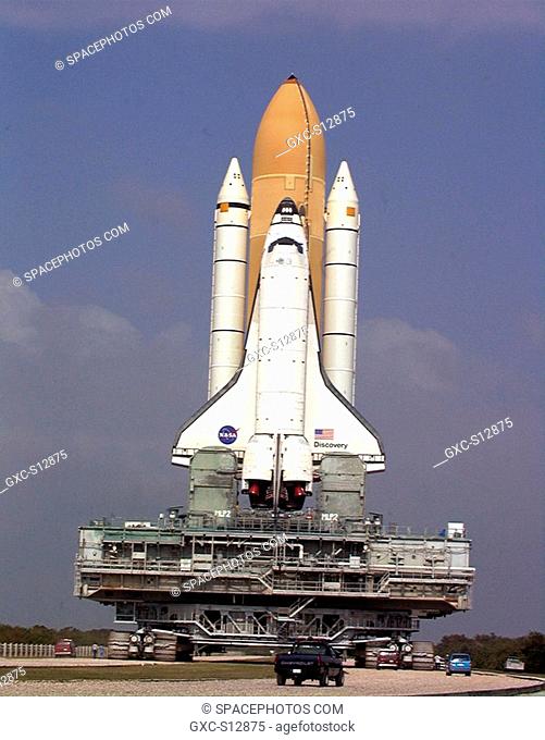 11/13/1999 -- Towering atop the mobile launcher platform and crawler transporter, Space Shuttle Discovery negotiates a turn in the crawlerway on its trek from...