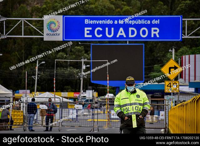 Colombia's police guard protests with the sign that reads ""Welcome to Ecuador"" as drivers of public service vehicles hold protest on the Rumichaca...