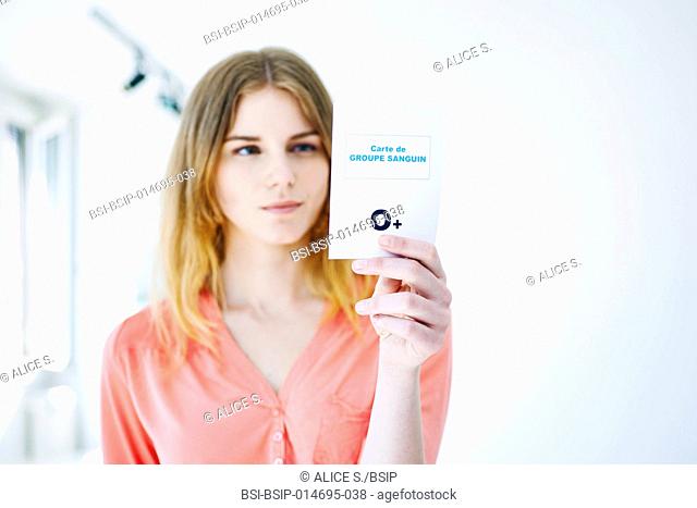 Woman holding her blood group card