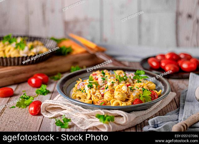 Italian tortellini with herbs and cheese sauce