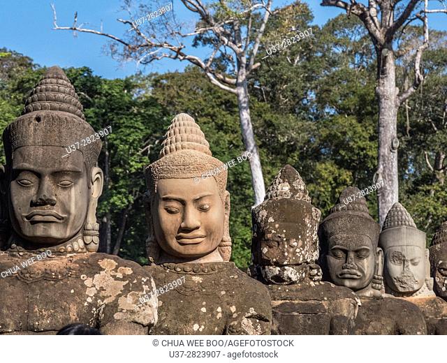 Detail of the stone faces on the bridge at the south gate of Angkor Thom, Angkor Temples complex, Cambodia, Asia