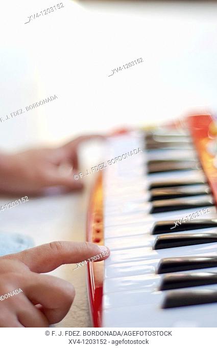 Hand boy playing electronic piano
