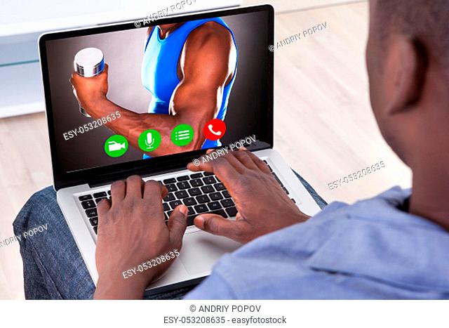Close-up Of African Man Typing On Laptop