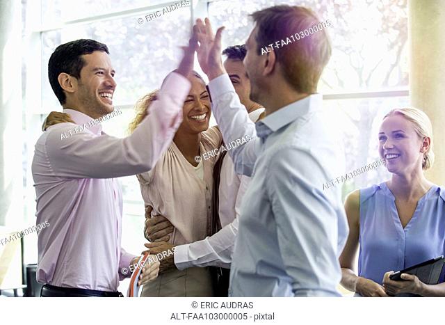 Colleagues giving each other high-five