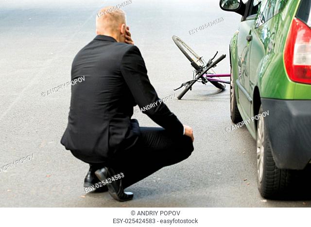 Sad Male Driver After Collision With Bicycle On Road