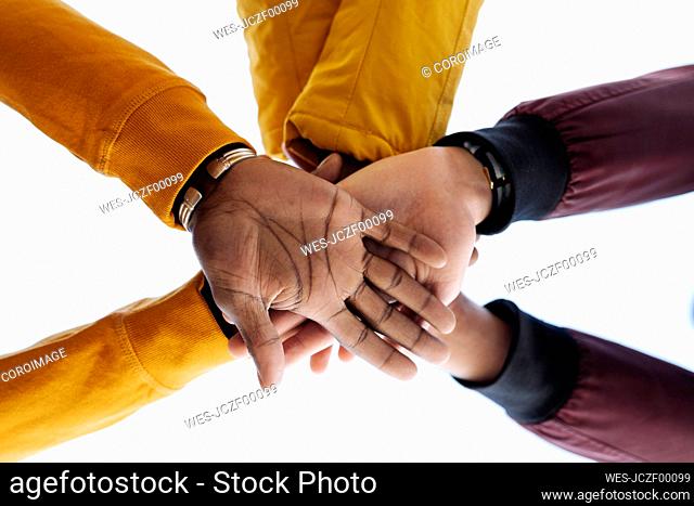 Close-up of friends stacking their hands