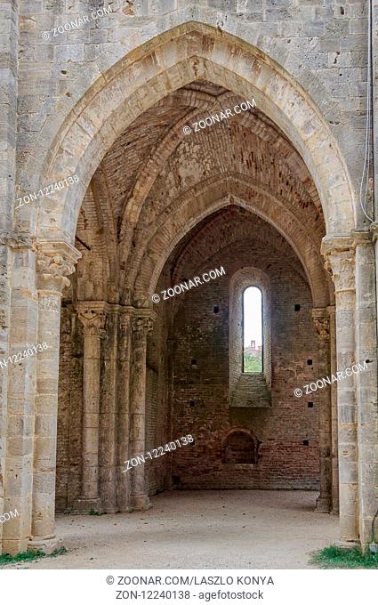 The bell tower of Hermitage of Monte Siepi seen through a window of the former Cistercian Abbey - San Galgano, Tuscany, Italy