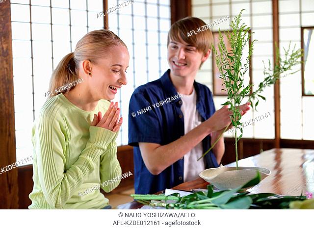 Caucasian couple practicing ikebana at traditional Japanese house