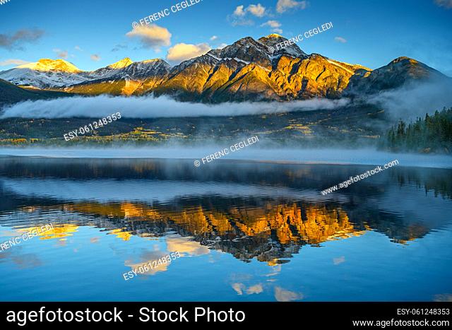 Gorgeous sunrise over the Pyramid Mountain that is beautifully reflecting in the Pyramid Lake in Jasper National Park, Alberta, Canada