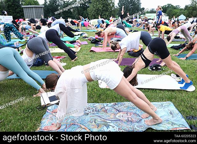 RUSSIA, MOSCOW - JULY 2, 2023: People do exercises during Yoga Day Russia 2023, a yoga festival marking the International Day of Yoga, in Tsaritsyno Park