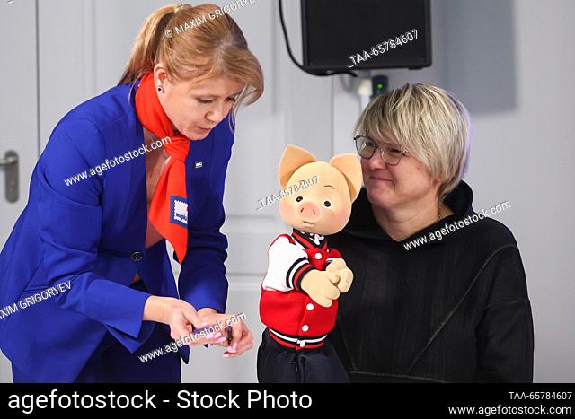 RUSSIA, MOSCOW - DECEMBER 15, 2023: Actress Oksana Chabanyuk (R), the voice of Khryusha the Piglet, attends a ceremony to cancel postage stamps marking 60 years...