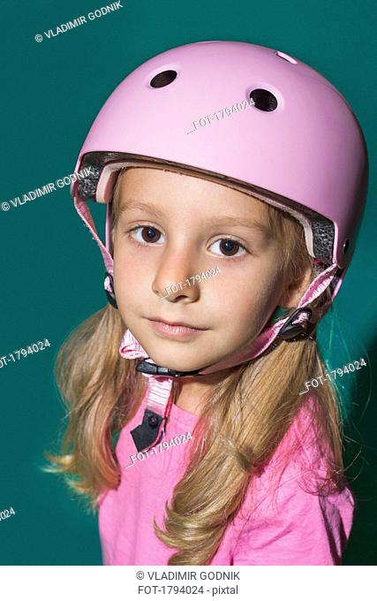 Close up portrait confident girl wearing pink helmet