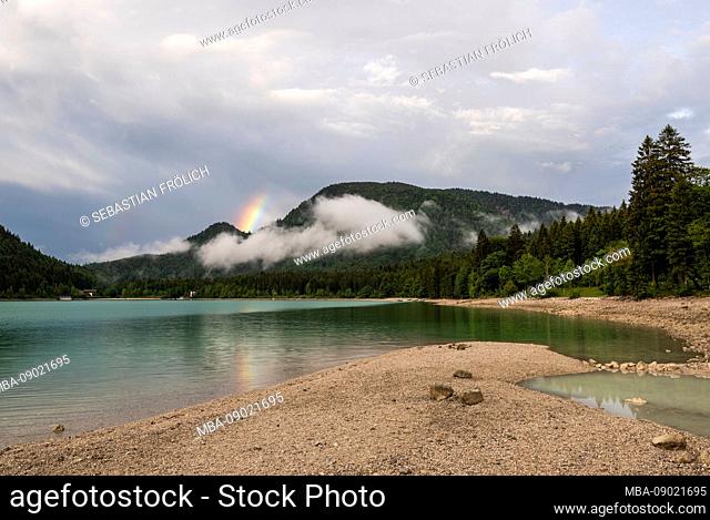 Small rainbow strip on the bank of the lake Walchensee in the Bavarian Prealps