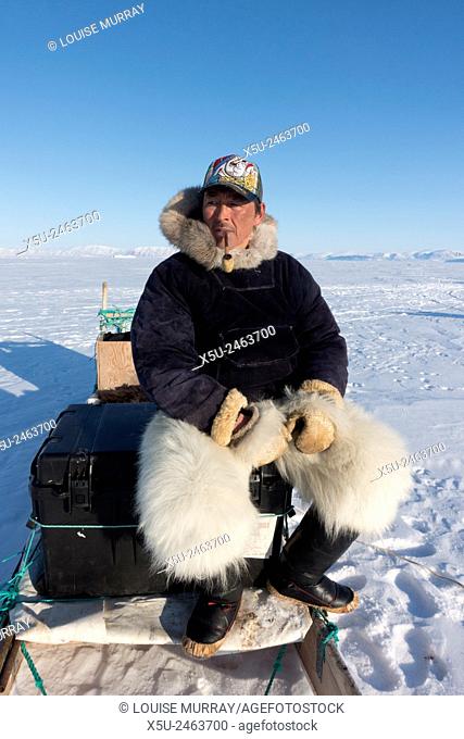 Inuit hunter smoking a pipe on the sea ice near Herbert Island - Niels Peter Miunge