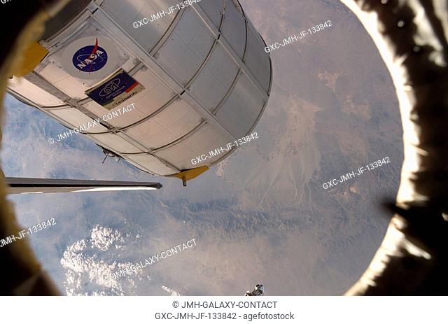 Canadarm2 or the Space Station Remote Manipulator System (SSRMS) arm (out of frame) grasps the Italian-built Multi-Purpose Logistics Module Leonardo to place it...