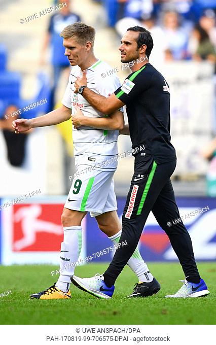 Bremen's Aron Johannsson and Bremen's coach Alexander Nouri leave the pitch after the ending of the German Bundesliga soccer match between 1899 Hoffenheim and...