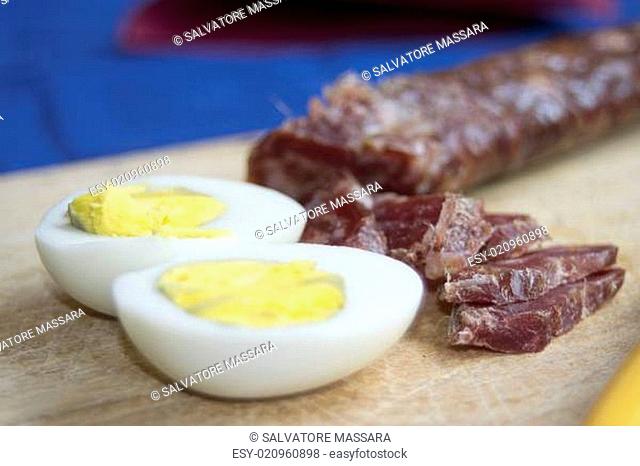 Italian Easter breakfast with salty pizza corallina salami and hard-boiled eggs
