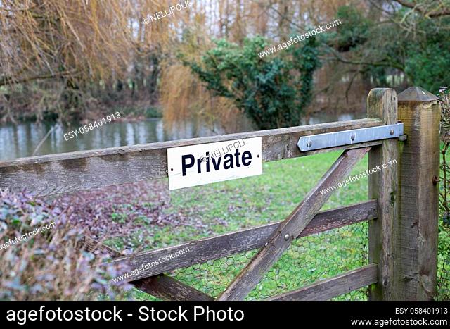 Private sign on farm wooden gate. Leading to spring meadow, field