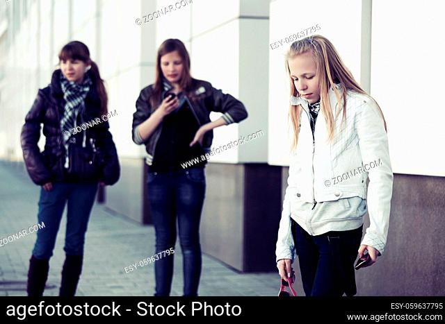 Group of teen girls with a cell phone on the street