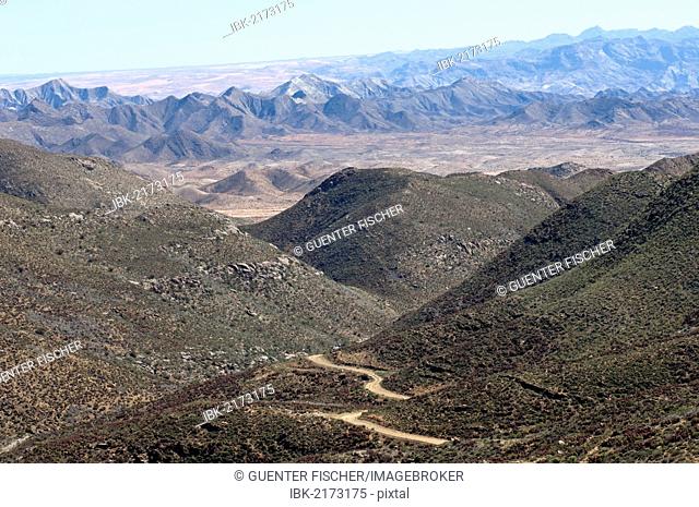 Dry valley with road in a Karoo landscape at Helskloof Pass, Richtersveld National Park, Namaqualand, Northern Cape Province, South Africa, Africa