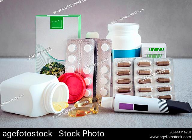 Various forms of drugs: tablets, ampoules, tinctures, blister packaging on a light background. The place to insert the text. Medicine and pharmacy