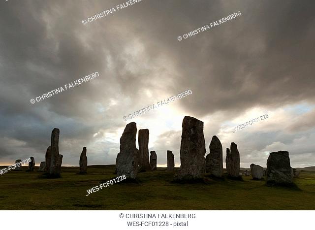 UK, Scotland, Isle of Lewis, Callanish, view to formation of standing stones at backlight