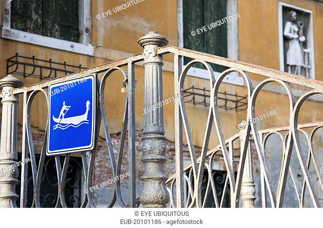 Centro Storico Gondola access via iron stairway indicated with tourist sign in blue and white