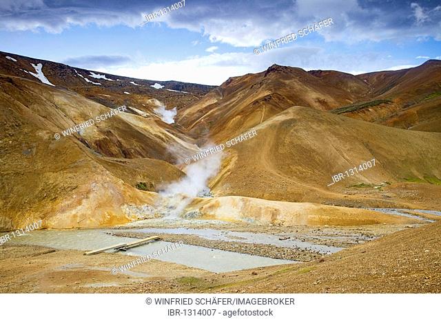 Kerlingarfjoell geothermal area, mineral-colored hills and colorful rhyolite mountains underneath the Kerlingarfjoell glacier, streams, Iceland, Europe