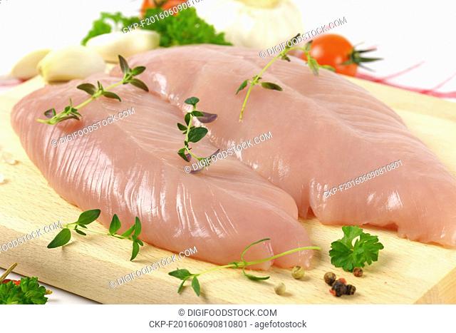 raw turkey breasts with vegetables, spice and herbs