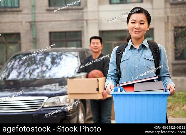 Student portrait in front of dormitory at college
