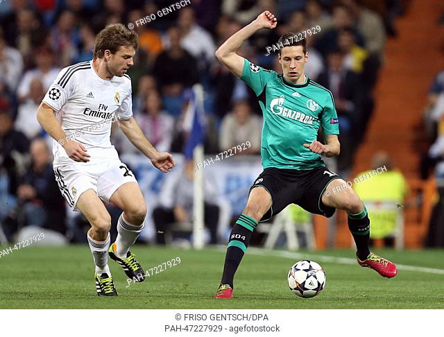 Real Madrid's Asier Illarramendi (L) and Julian Draxler (R) of Schalke vie for the ball during the Champions League round of 16 second leg soccer match between...