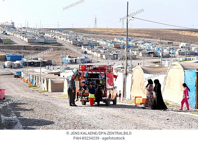 A car selling household objects is parked between tents in the Mamilian refugee camp in the Dohuk region, Iraq, 19 October 2016
