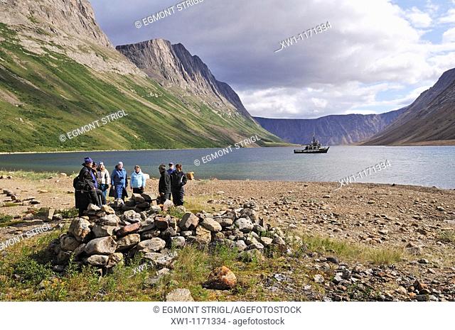 group of tourists at a historic Inuit foodcache at North Arm of Saglek Fjord, Torngat Mountains National Park, Newfoundland and Labrador, Canada