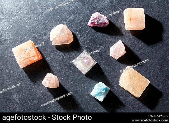 quartz crystal pyramid and gem stones on slate